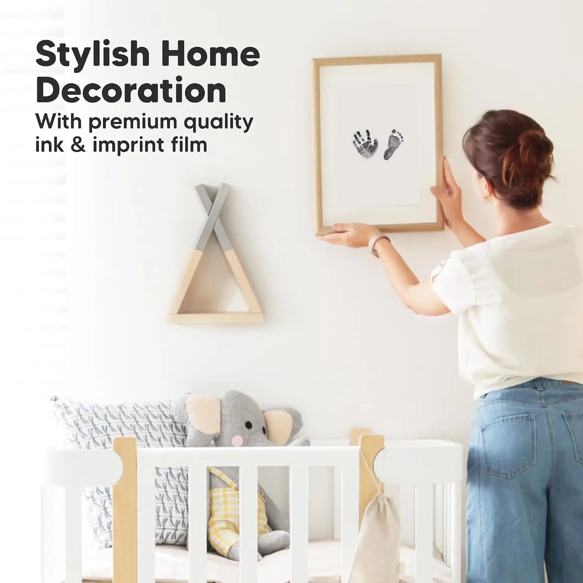 A woman decorates a framed piece of art with ink and imprint film for a stylish home decoration project.