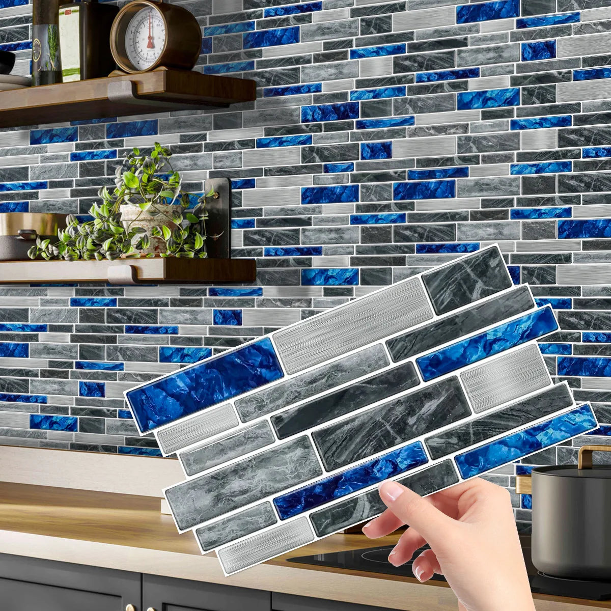 A hand is applying a crystal film marble wall decal featuring blue and gray marble patterns onto a tiled backsplash.