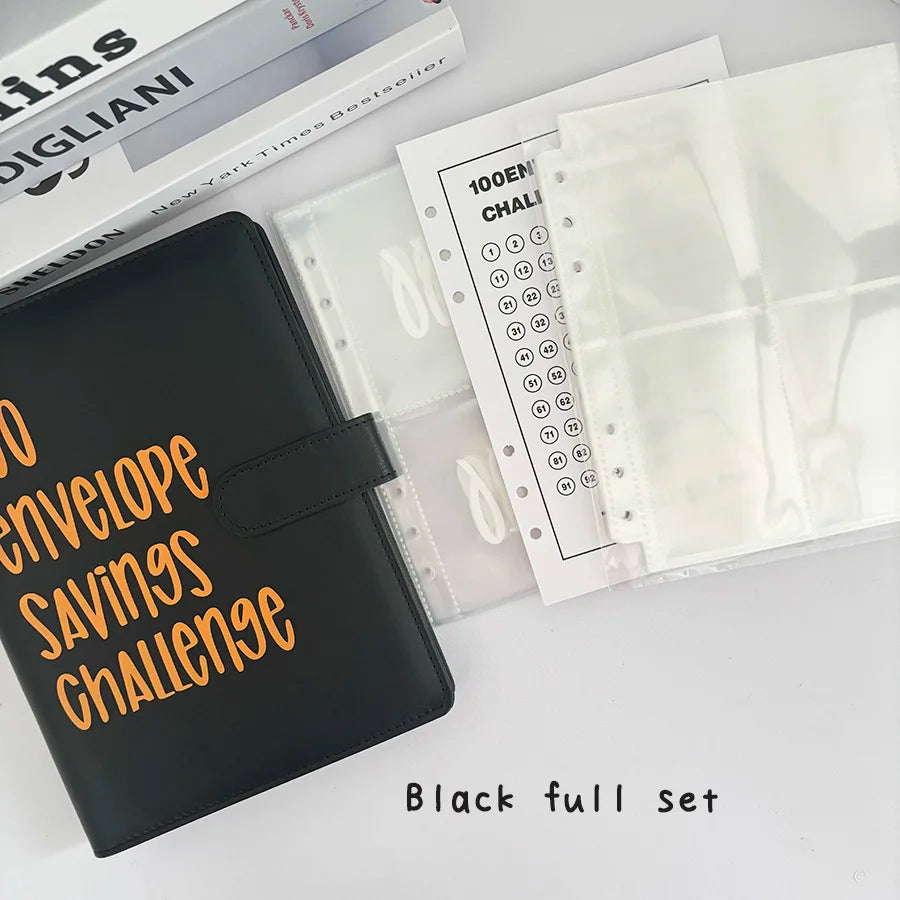 A black full set of A5 100-envelope savings challenge binders with numbered pockets and a book.