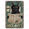 Décor mural vintage en métal d'un chat noir aux yeux verts regardant directement l'observateur.