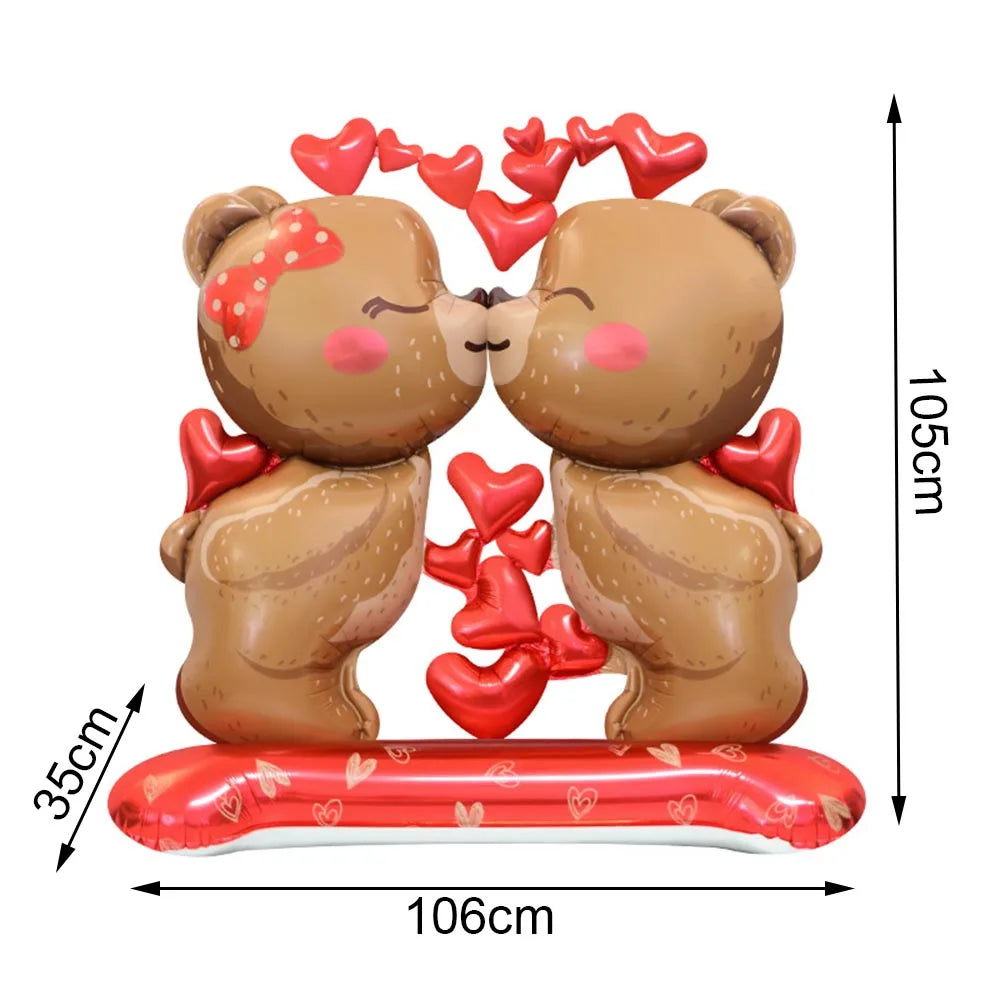 A pair of cute brown teddy bear figurines made of foil-finish material with red heart letter balloons.