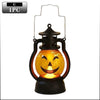 A black lantern shaped like a carved pumpkin with an orange glow and a smiling face projection.