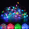 A bundle of RGBIC color changing LED fairy string lights in various colors glowing brightly.