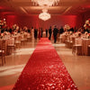 A long red sparkling aisle runner leading down a grand ballroom with tables and a chandelier.