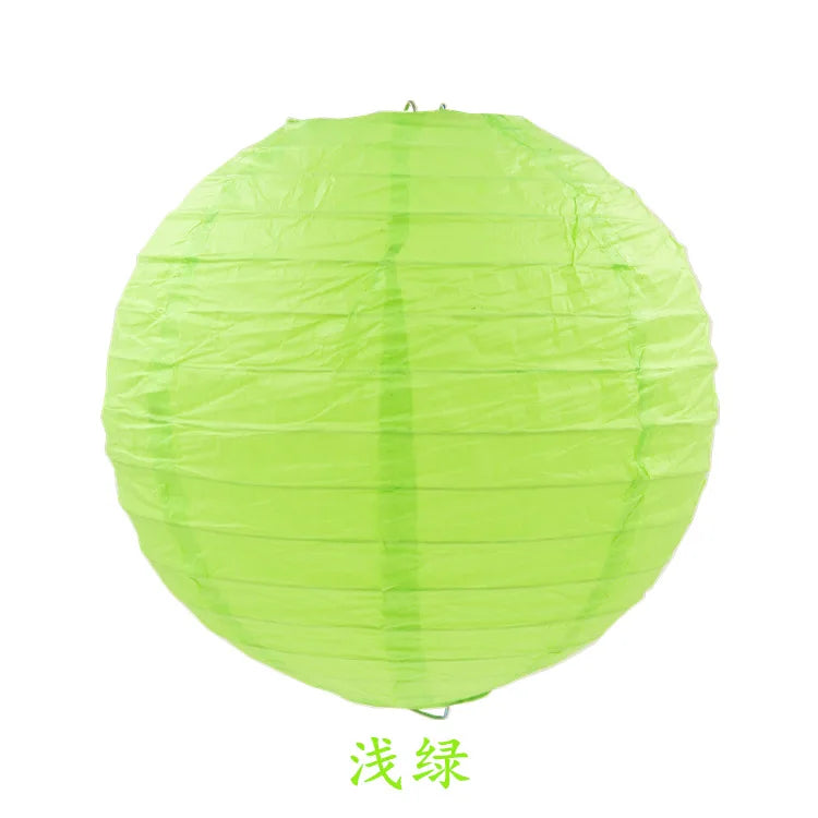 A round, translucent lime green paper lantern.