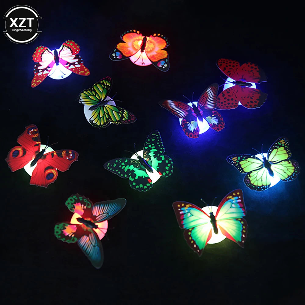 A collection of glowing 3D LED butterflies in various colors and patterns against a dark background.
