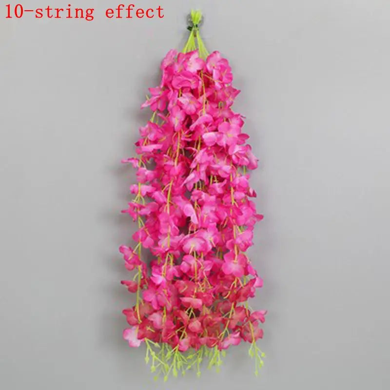 A vertical arrangement of pink artificial wisteria flowers forming a long, hanging garland.