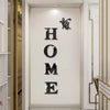 A decorative wall sticker featuring the word HOME in black lettering with a butterfly silhouette above it.