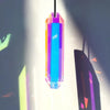 A vertical pendant featuring a prismatic crystal with rainbow colors hanging against a bright background.