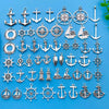 A collection of silver vintage ship anchor charms and pendants for jewelry making displayed on a blue background.