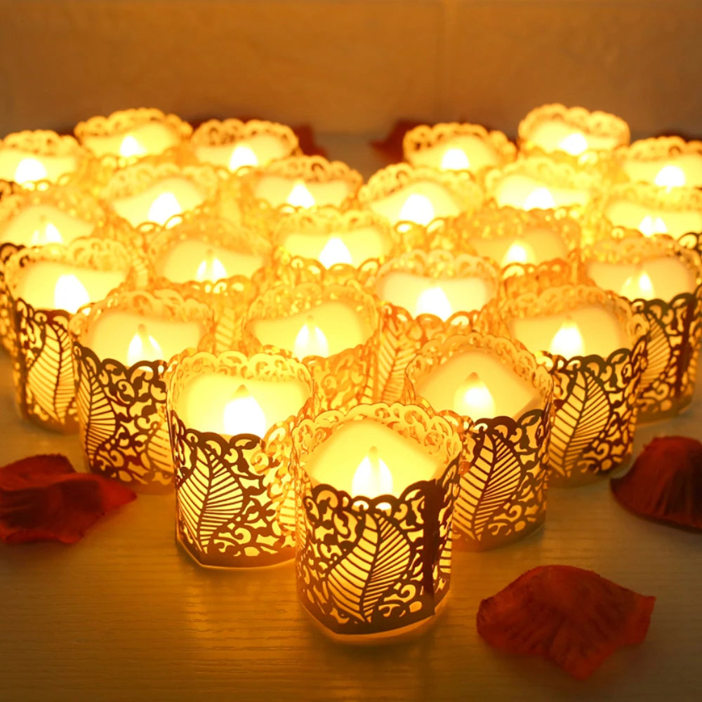 A collection of glowing yellow LED tea light candles in ornate paper lampshades arranged on a wooden surface.