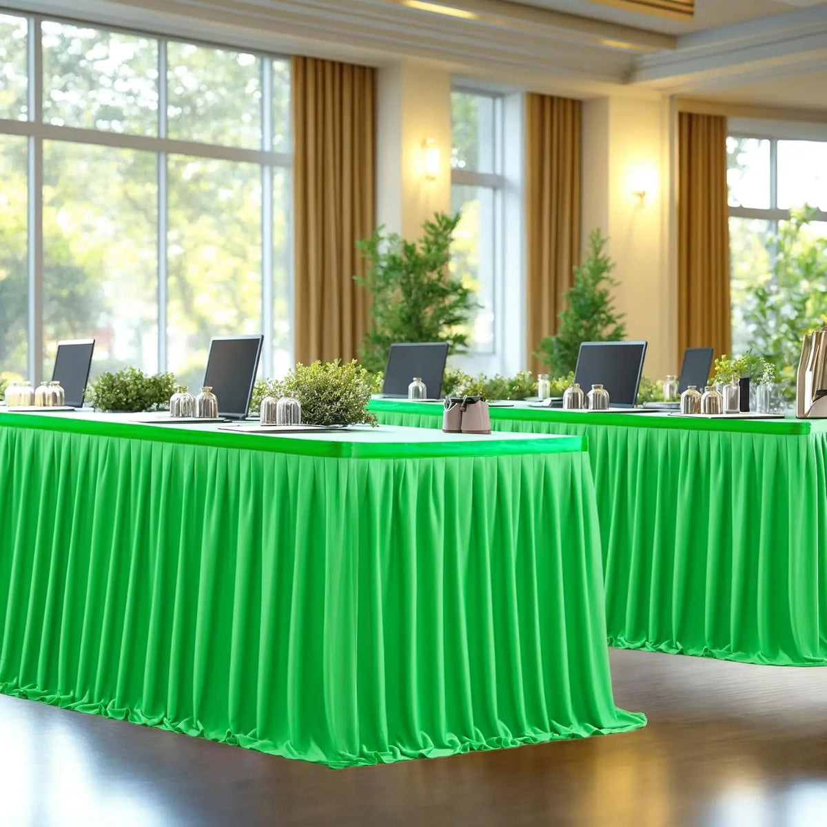A vibrant green pleated polyester table skirt set up for a dining or banquet event.