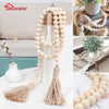 Boho farmhouse tassel bead wall hanging featuring light beige wooden beads and natural fiber tassels