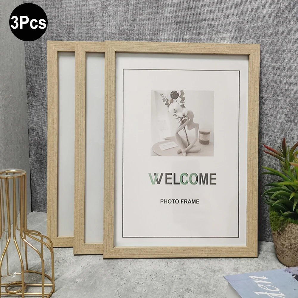 A light wood photo frame with glass panels is displayed against a gray wall, showing a welcome message.