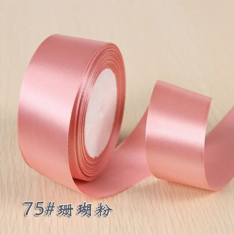 Roll of pink silk satin ribbon for gift wrapping and craft projects