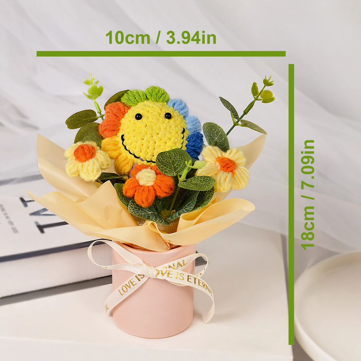 Handmade crochet sunflower bouquet with green leaves presented in a pink gift box