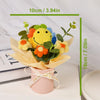 Handmade crochet sunflower bouquet with green leaves presented in a pink gift box