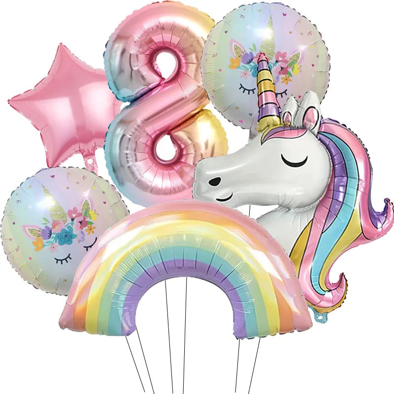 A collection of pink and iridescent foil balloons, including a number 8, a star, and a unicorn head, along with a rainbow arc