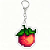 A shiny silver acrylic keychain charm shaped like a red strawberry with green leaves.
