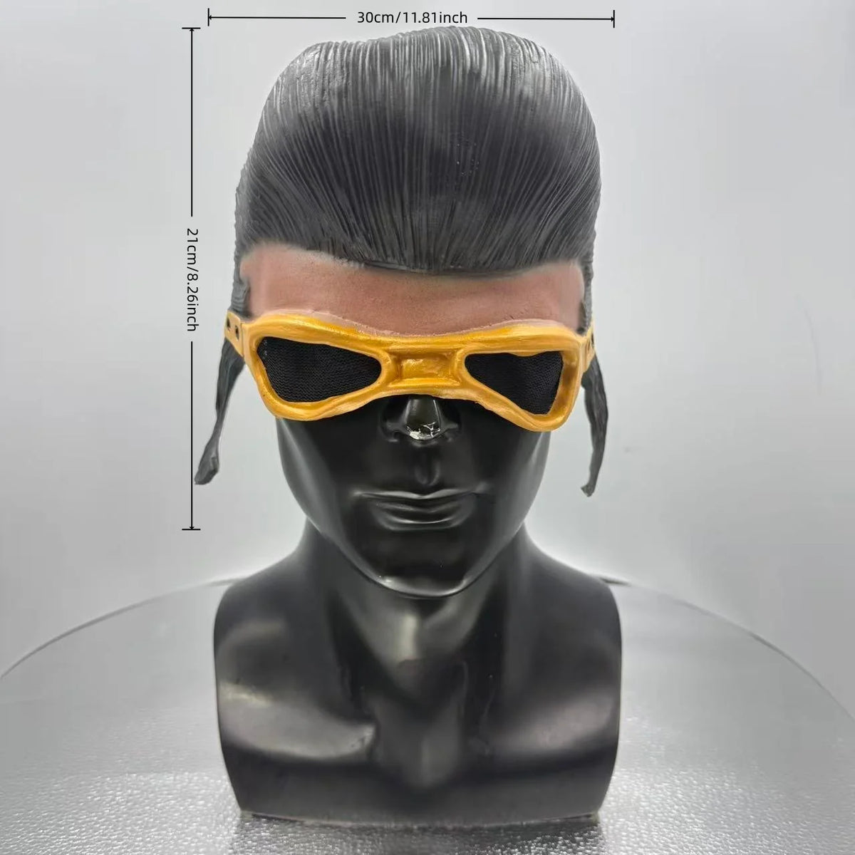 A black mannequin head wearing a yellow latex half-face mask designed for costume and stage use.