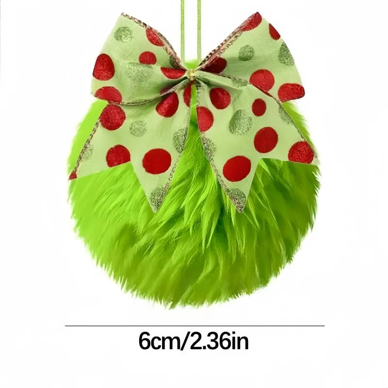 A festive green faux fur Christmas ball ornament with a red polka dot bow.