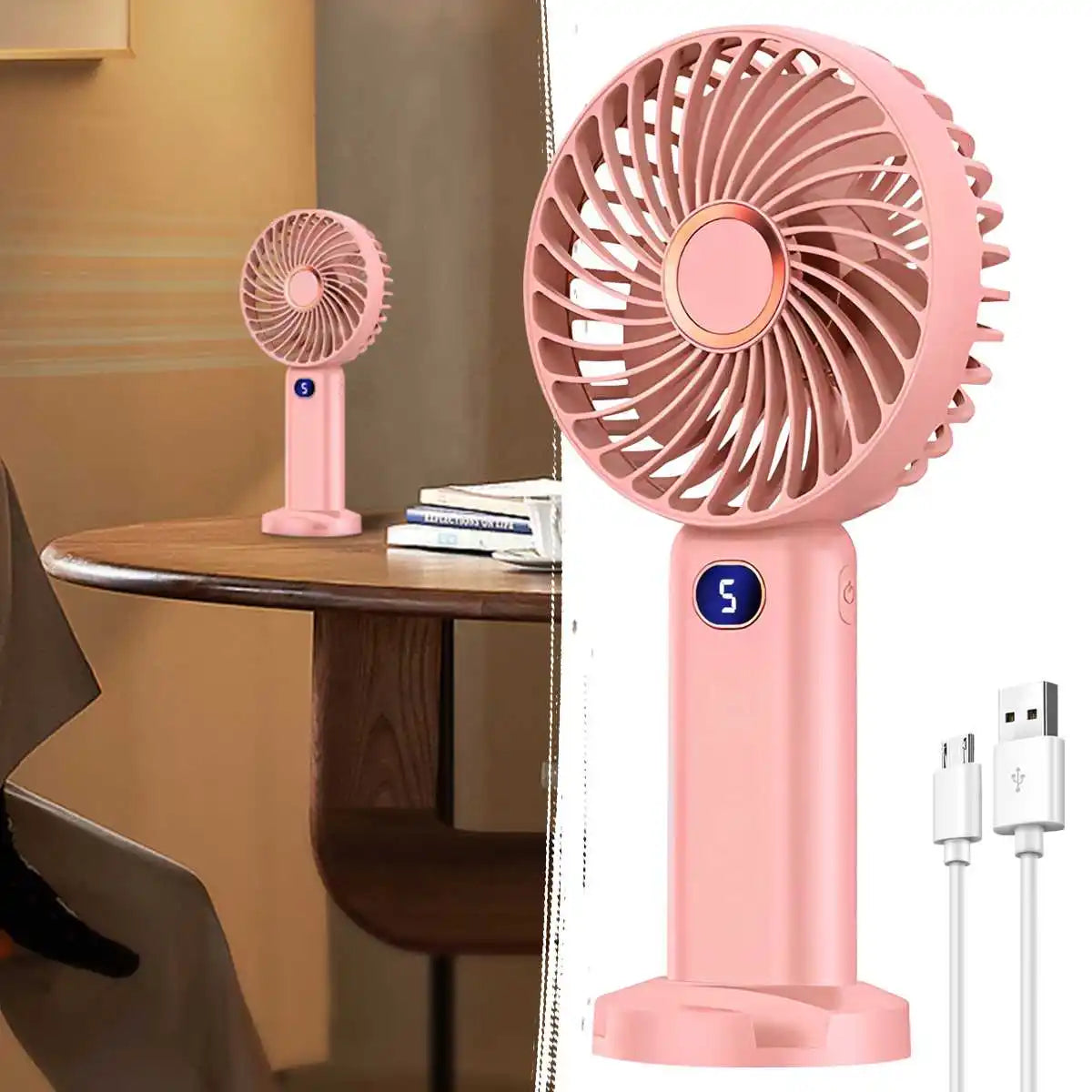 A pink portable rechargeable handheld fan with a circular grille and digital display is shown on a wooden table.