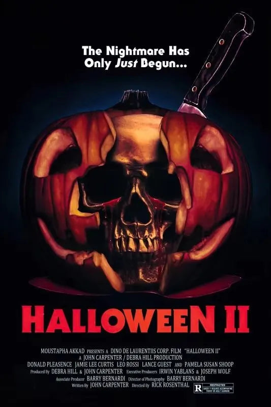 Halloween II poster featuring a carved pumpkin skull and a knife against a dark background