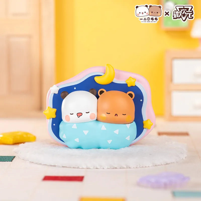 A cute collectible doll featuring a white and orange bear face with yellow accents, displayed on a white fuzzy surface.