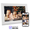 A white photo frame displays a warm scene of two women reading together in front of a decorated Christmas tree.