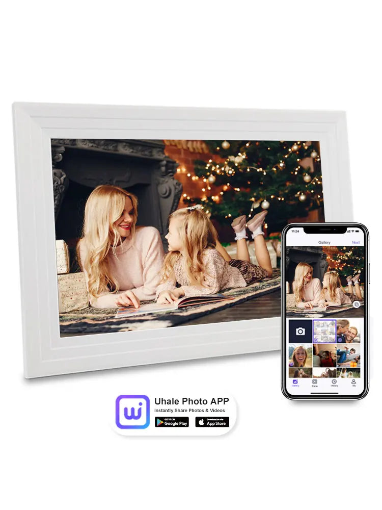 A white photo frame displays a warm scene of two women reading together in front of a decorated Christmas tree.