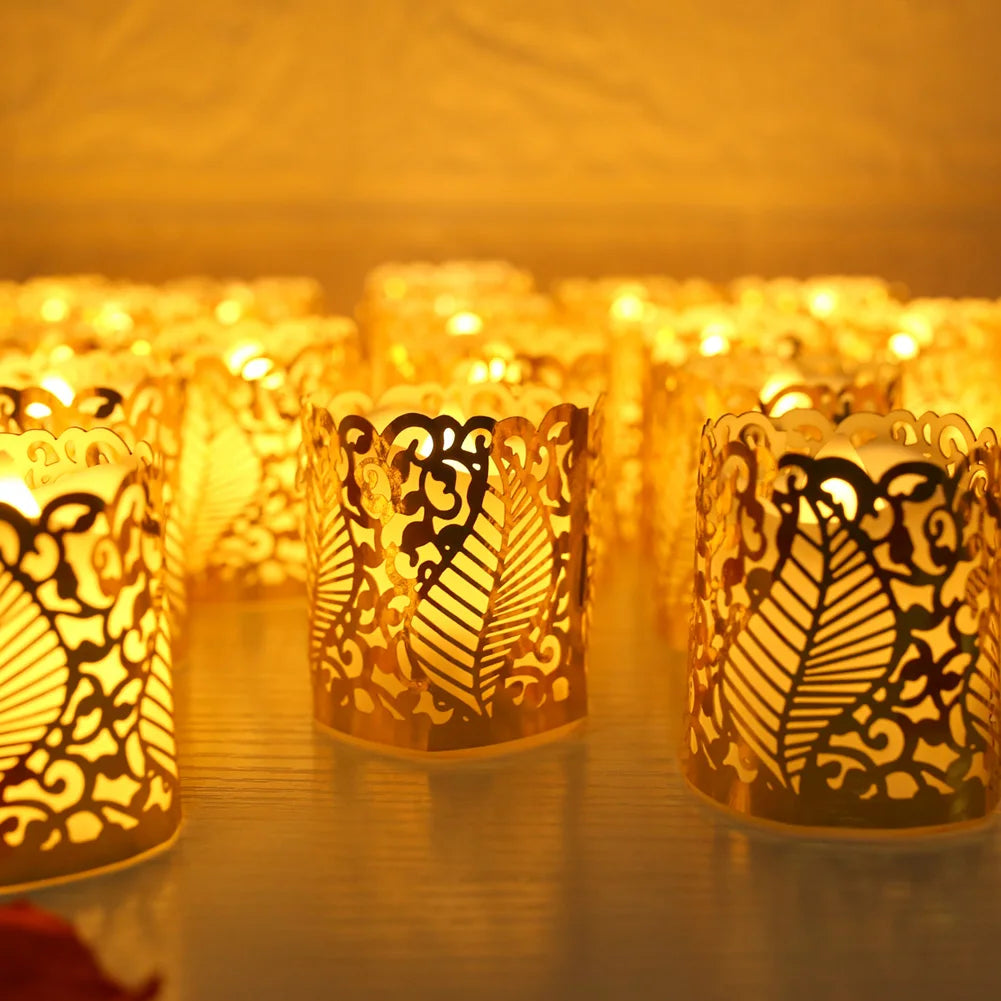 A close-up of numerous glowing gold LED tea light candles in decorative paper lampshades arranged on a wooden surface.