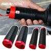 A hand holds a black silicone grip cover for a motorcycle handlebar, with several rolled-up covers displayed below.