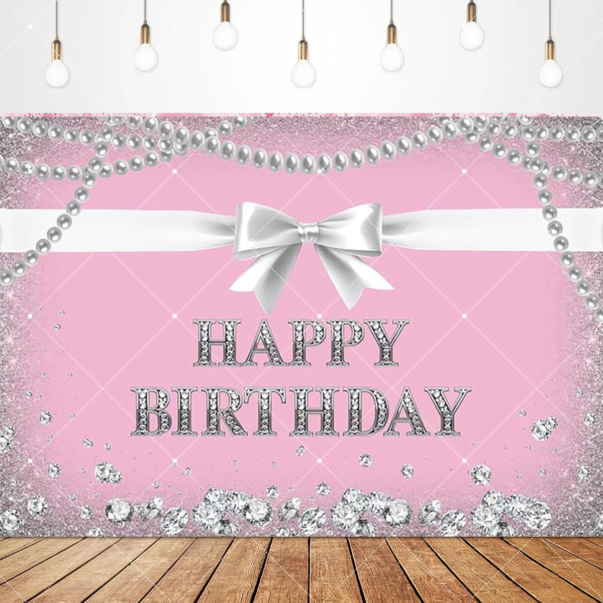 Pink glitter backdrop banner with a white bow and birthday text on a wooden surface.