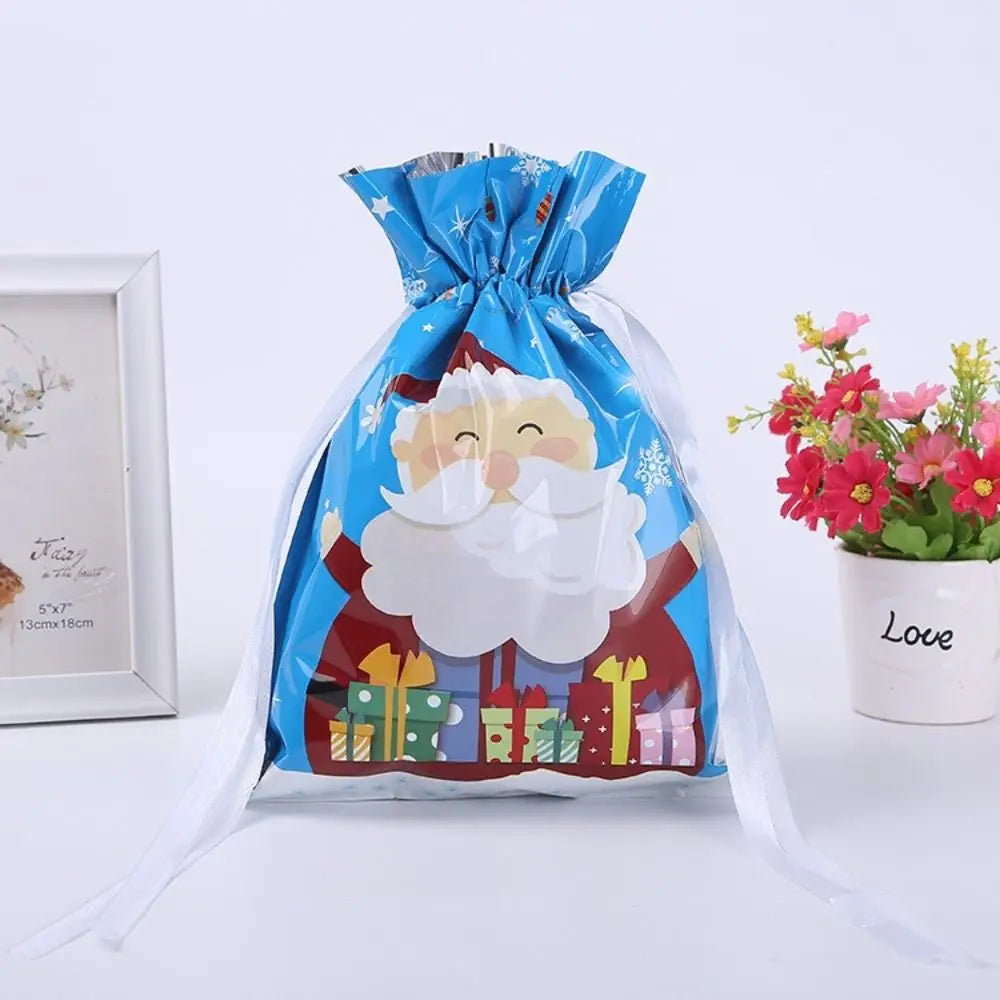 Blue drawstring gift bags featuring Santa and snowman designs with festive patterns