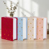 A set of five laminated photo albums in red, blue, peach, and white with gold hearts on the cover.