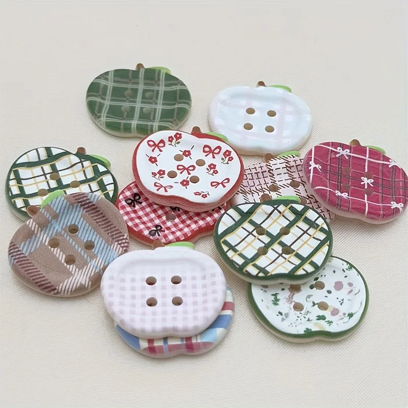 A set of eight heart-shaped fridge magnets featuring various plaid, polka dot, and patterned designs in green, pink, and whit