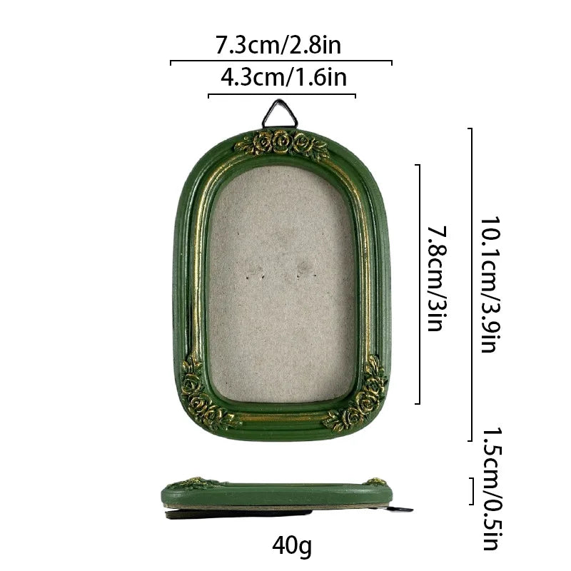 A vintage baroque resin picture frame in olive green with a rectangular glass insert and decorative molding.