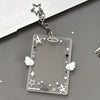 Silver keychain featuring an acrylic card holder with stars and clouds