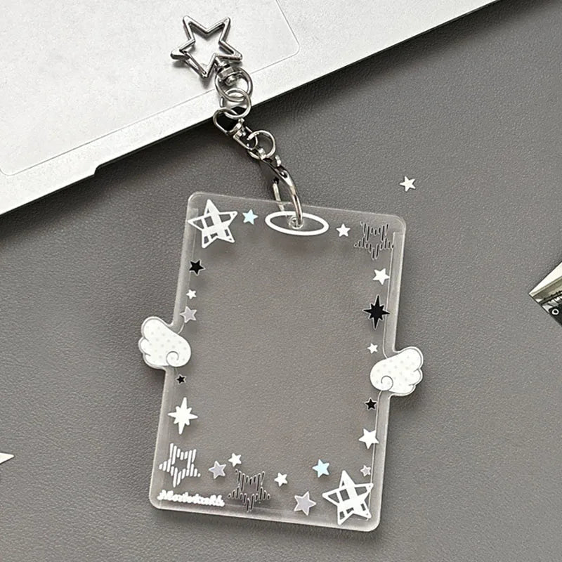 Silver keychain featuring an acrylic card holder with stars and clouds