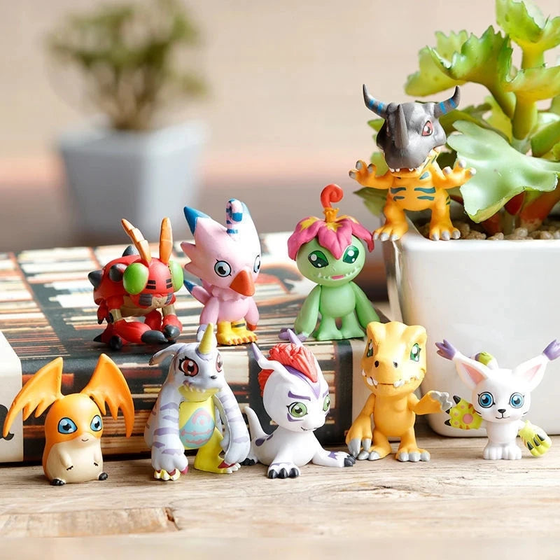 A collection of Digimon Adventure 9-figure collectible figures featuring various monster designs in bright colors.