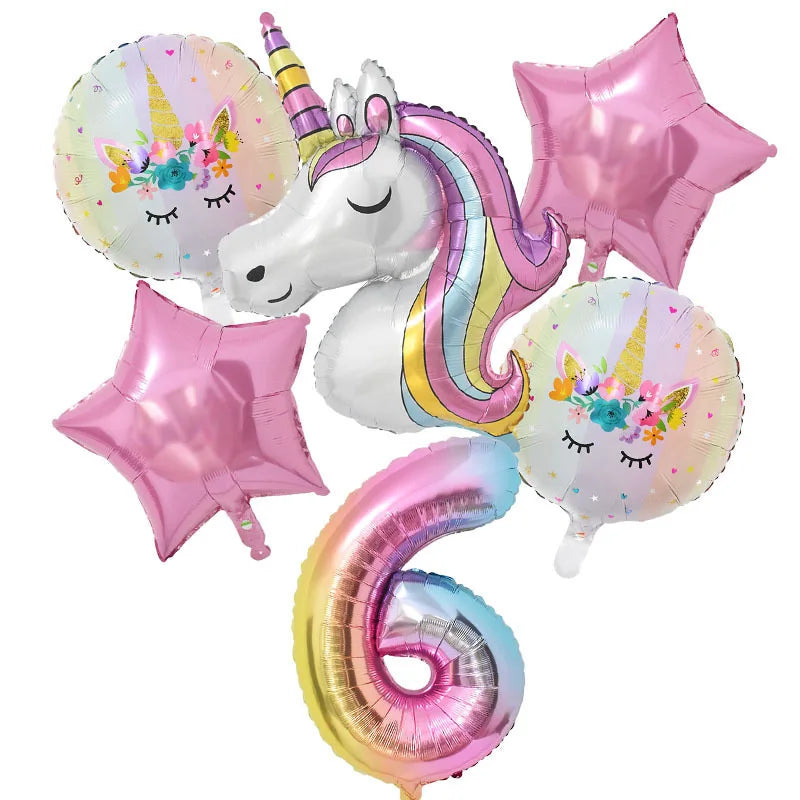 A collection of pink and iridescent balloons featuring unicorn and star decorations for a birthday party.