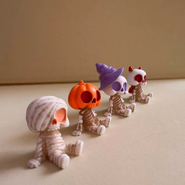 A set of five spooky resin Halloween decor figures in various colors including orange, purple, and red.