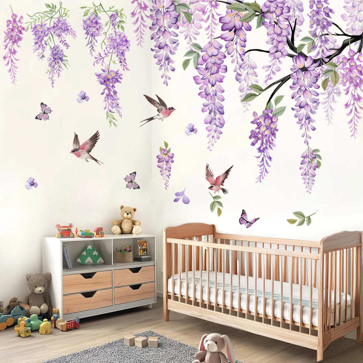 Wall decals featuring watercolor wisteria vines, birds, and butterflies decorating a nursery room.