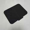 Black silicone drain mat with textured surface for kitchen sink