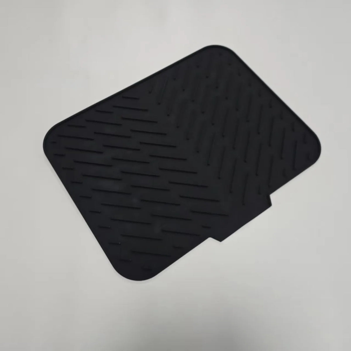 Black silicone drain mat with textured surface for kitchen sink