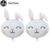 A pair of white cartoon bunny foil balloons with long ears and cute facial features.