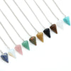 Multiple silver necklaces featuring natural stone pendants in various colors including green blue pink and black