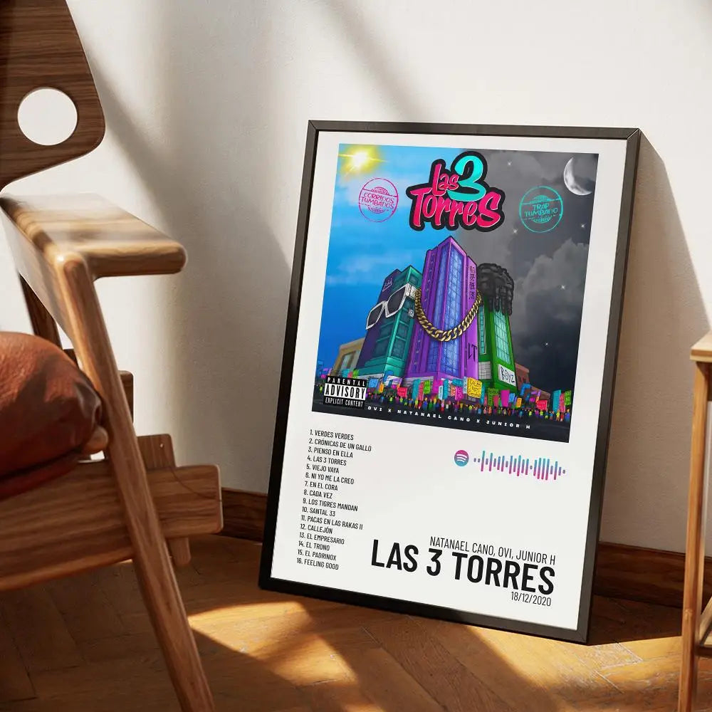 A framed poster featuring the album art for Lee Torres titled Las 3 Torres with a vibrant cityscape and musical elements.