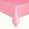 A pink disposable solid color tablecloth draped over a table.