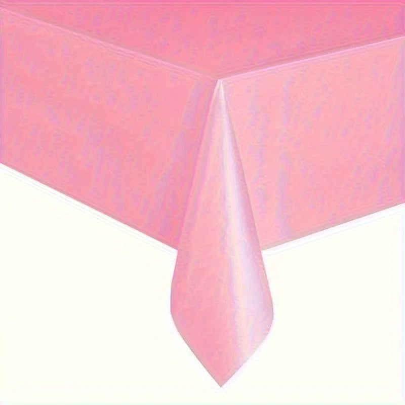 A pink disposable solid color tablecloth draped over a table.
